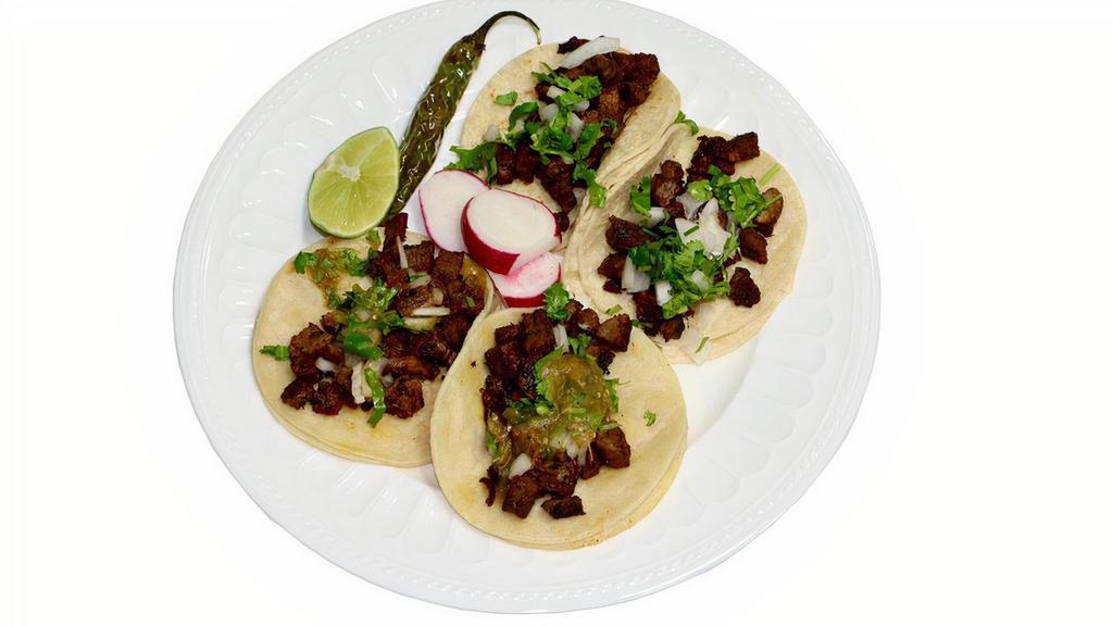 #4 - 4 Tacos · Always a fave! The famous street tacos! Corn tortilla tacos with your choice of protein. Topped with onions, cilantro, and house made tasty mild tomatillo salsa! Garnished with a lime, radishes, and a serrano pepper.