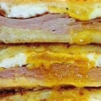 Breakfast Sandwich · 2 Slices of Grilled Sourdough Piled High with Honey Ham and 2 Eggs Over Medium with Melted A...