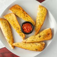 Garlic Bread · French bread seasoned with garlic and spices. Includes marinara side.