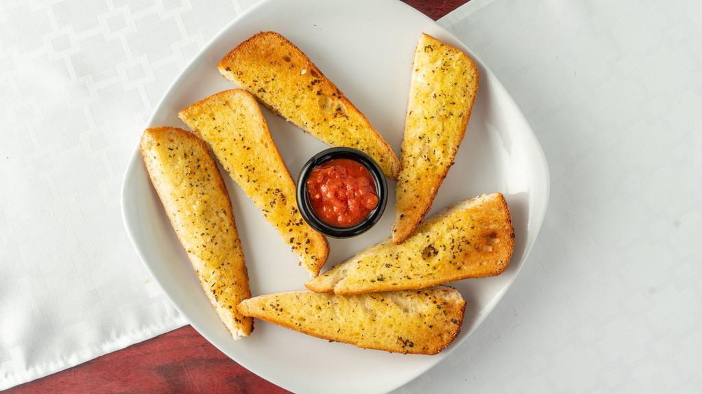 Garlic Bread · French bread seasoned with garlic and spices. Includes marinara side.