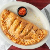 Chicken Blanco Calzone · Alfredo sauce, mushrooms, onions, grilled chicken, and roasted red peppers with mozzarella c...