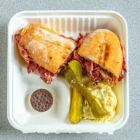 Pastrami Dip Sandwich · Thin sliced, grilled pastrami on a large hoagie roll, served with au jus and potato salad. T...