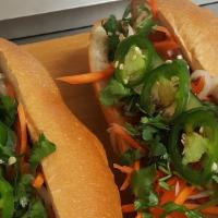 Banh Mi Thit Nuong · Grilled pork sandwich. A fresh French baguette filled with cilantro, jalapeno peppers, pickl...