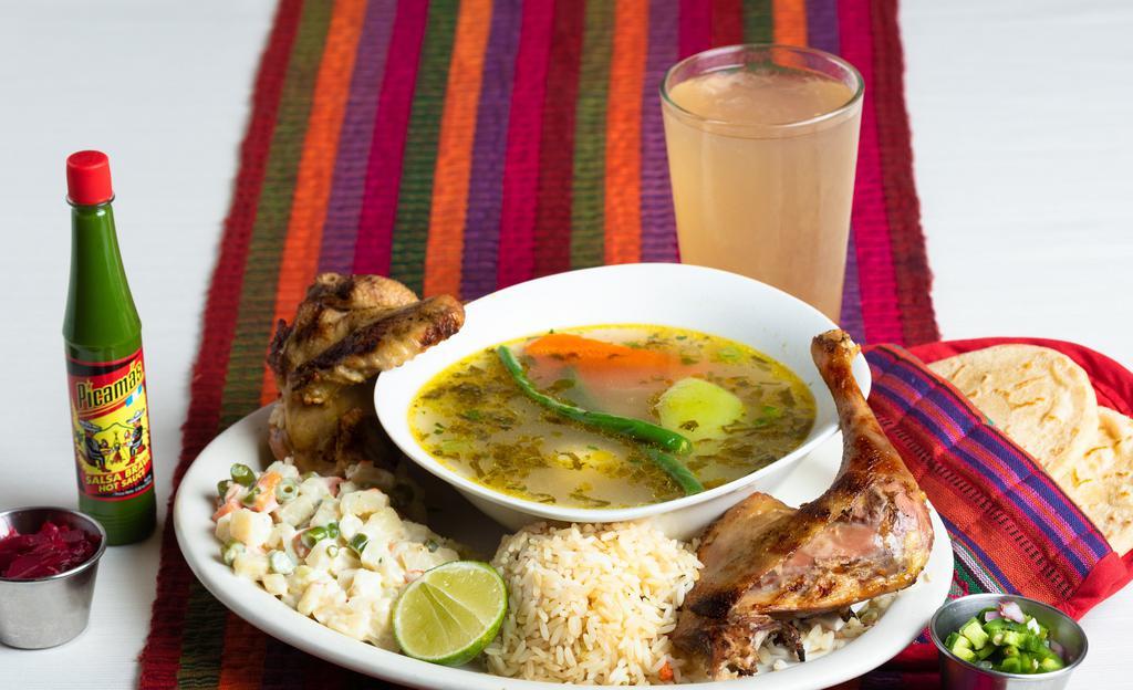 Caldo De Gallina · Traditional hen soup with vegetables.  Served with rice and grilled hen on the side. Sopa tradicional de gallina con vegetales.  Servida con arroz y gallina asada al lado