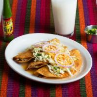 Dobladas De Res  · Fried tortillas with beef or chicken cabbage and onion, accompanied by cabbage salad with ho...
