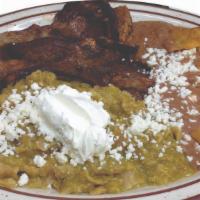 Chilaquiles · Deep-fried corn tortillas strips and mixed with a spicy tomatillo sauce - topped with queso ...
