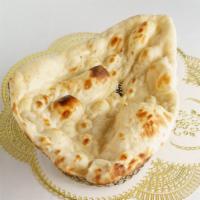 Naan · Leavened fine flour bread baked in tandoor.