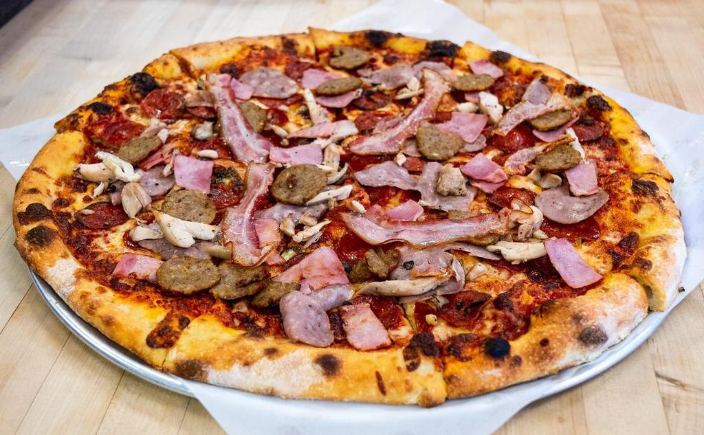 Omg Carnivore · Sausage, pepperoni, meatballs, chicken, ham, bacon, crushed tomatoes, basil, aged mozzarella.
