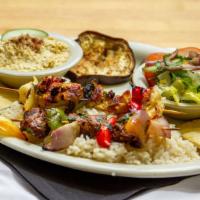Sample Plate · Choice of two kebabs, served w/ hummus, grilled eggplant, dolma, rice, salad and pita.
