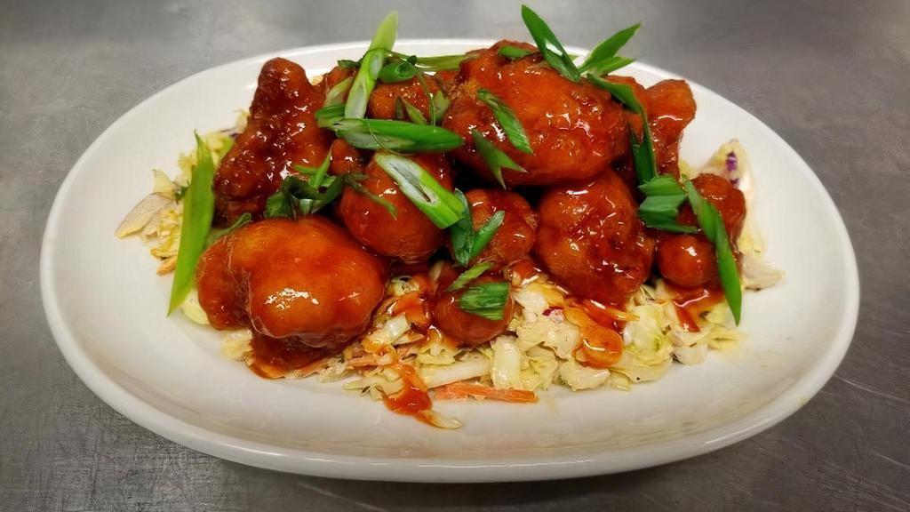 Cauliflower Honey Sriracha Wings · Cauliflower florets dusted with seasoned flour, crispy fried, sauced and tossed in sweet and spicy honey sriracha, served with blue cheese dressing.