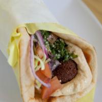 Falafel · Vegan. Falafel, hummus, lettuce, onions, tabbouleh topped with tahini sauce.