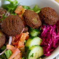 Falafel Salad · Vegetarian. 
Four pieces of falafel served on a Greek salad topped with tahini sauce and fet...