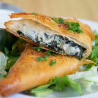 Spanakopita · Vegan. 
phyllo dough stuffed with spinach, feta cheese, onion served with tzatziki sauce.