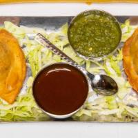 Vegetable Samosa (G) · pastry filled with spiced potatoes & green peas, fried