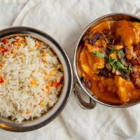 Chicken Curry · Traditional dish cooked with boneless chicken, onion, garlic ginger, tomatoes, and curry spi...