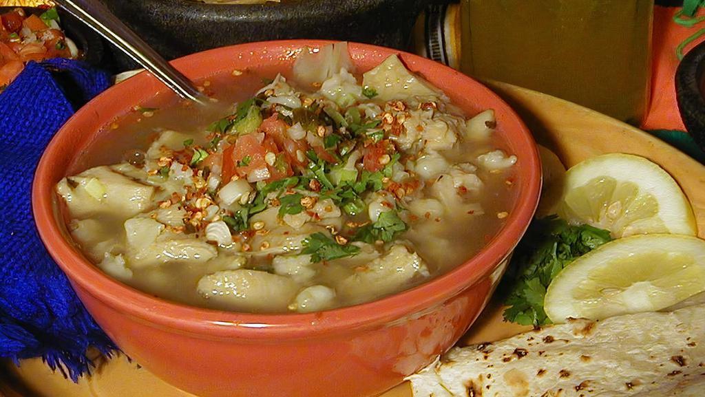 Menudo White · Delicious Red or  White Menudo served with a Flour Tortilla, Lemons, Cilantro, Crushed Red Pepper, Green Onions, our famous  2 oz. Hot Sauce