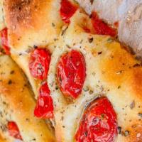 Focaccia Mediterranea · Focaccia topped with cherry tomatoes, oregano, and EVO oil is the Mediterranean bread for ex...