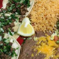 Carne Asada Street Tacos · Three steak soft tacos topped with cilantro and onion.
