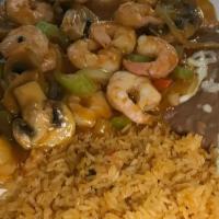 Camarones Mexicanos · Shrimp sautéed in spicy salsa with mushrooms, onions, tomatoes, and bell peppers. Served wit...