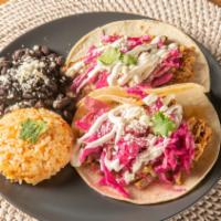 A Pair Of Tacos · Corn tortillas, served with beans and rice.