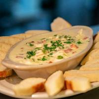 Do You Feel Like I Fondue · Baked fondue of chicken, parsley, roasted red bell peppers, green chiles, mozzarella and par...