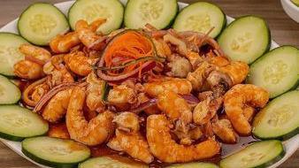 Shrimp Platter · Cooked shrimp, cucumber, onion, avocado and black sauce.