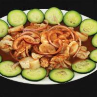 Aguachile With Scallops · Shrimp cooked in lime juice, scallops, cucumber, onion and black sauce.