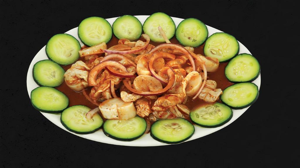 Aguachile With Scallops · Shrimp cooked in lime juice, scallops, cucumber, onion and black sauce.