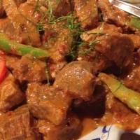 Panang Curry · Spicy. Simmered in rich red curry paste and coconut milk with flavored of peanut sauce, bell...