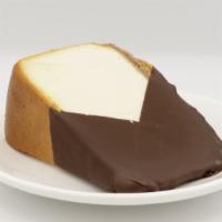 Colossal Chocolate Covered Cheesecake Slice · New York style cheesecake on a buttery graham cracker crust, covered in chocolate.