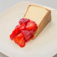 Colossal Strawberry Topped Cheesecake Slice · New York style cheesecake on a buttery graham cracker crust, covered with a strawberry toppi...