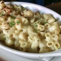 Mac & Cheese · Vegetarian. Super secret blend of cheeses topped with bread crumbs and fresh chives.