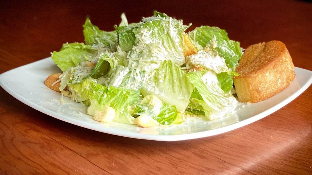 Caesar Salad · Romaine lettuce tossed with shredded parmesan, caesar dressing and garlic croutons.