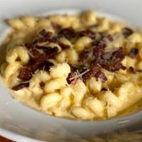 Three Cheese Mac · House made macaroni and cheese with monterray jack and cheddar cheeses, topped with fresh ch...