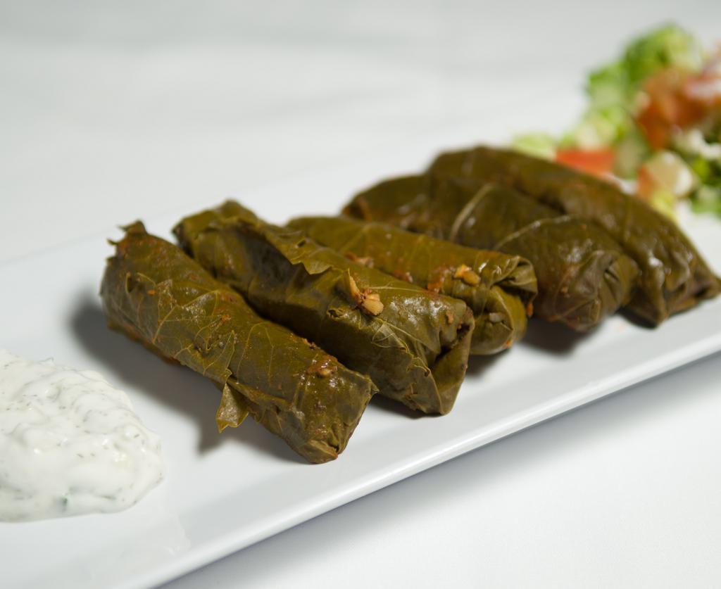 Dolmades · Ground beef, rice rolled in grape leaves topped with a lemon cream sauce.