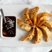 Pot Stickers · Ground pork stuffed in wrappers served with soy sauce.