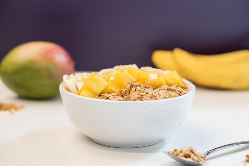 Tropical Bowl · Organic Acai blended with coconut milk and banana topped with sliced banana, fresh mango, gluten free granola, and local honey.