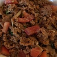 Timatim Fitfit · Pieces of injera bread mixed with chopped fresh tomato, onion,
jalapeño, and Ethiopian herbs...