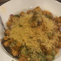 Samosa Chaat · Our famous samosa is topped with garbanzo beans, mint chutney, and tamarind chutney. This is...