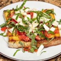 Bruschetta Baffi · Grilled homemade rustic bread, fresh tomatoes, buffalo mozzarella cheese, garlic, basil, and...