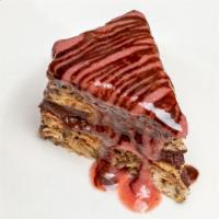 Chocolate Walnut Cake · Flourless Italian love cake, layers of genache and walnuts served on a bed of strawberry-ama...