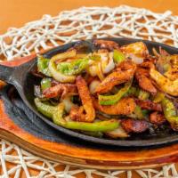Shrimp Fajitas · On a sizzling skillet with bell peppers, onions, guacamole and sour cream.