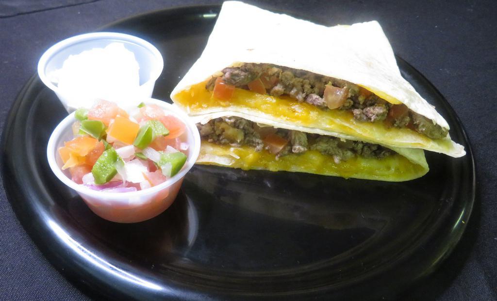Carne Asada Quesadilla · Carne asada quesadilla made with our fiesta cheese, marinated grilled steak, red onions, tomatoes and topped with sour cream and salsa.