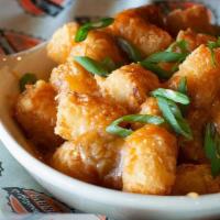 Green Chile Cheese Tots · Our crispy tots topped with our own recipe of Hatch Valley green chile and cheddar cheese
