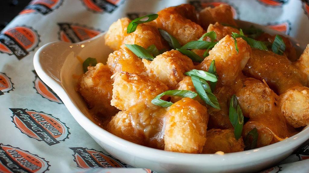 Green Chile Cheese Tots · Our crispy tots topped with our own recipe of Hatch Valley green chile and cheddar cheese