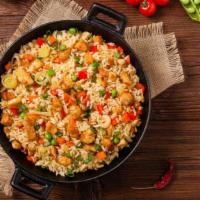 Chicken Fried Rice · Farm fresh chicken tossed with seasonal veggies including carrots, peas, scallions and garli...