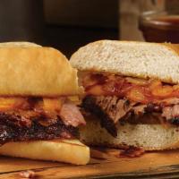 Pit Dip Sandwich · Sliced brisket, pit-smoked caramelized onions, ＆ cheddar cheese on a toasted hoagie bun. Ser...