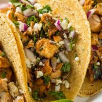 Grilled Chicken Taco · Delicious fusion taco made with seasoned grilled chicken, chopped onions, cilantro, cheese, ...