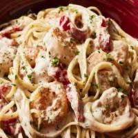New! Champagne Shrimp Pasta · Linguine tossed with shrimp in a champagne cream sauce with roasted red bell peppers and sau...