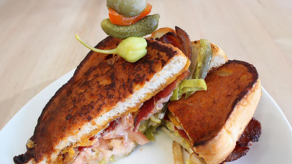 Ultimate Bloody Mary Grilled Cheese · Bloody Mary Battered & Grilled Sourdough / 
Horseradish Aioli / Sharp Cheddar / Havarti / Applewood Smoked Bacon / Housemade Pickles / Pepperoncini Pepper / Tomato